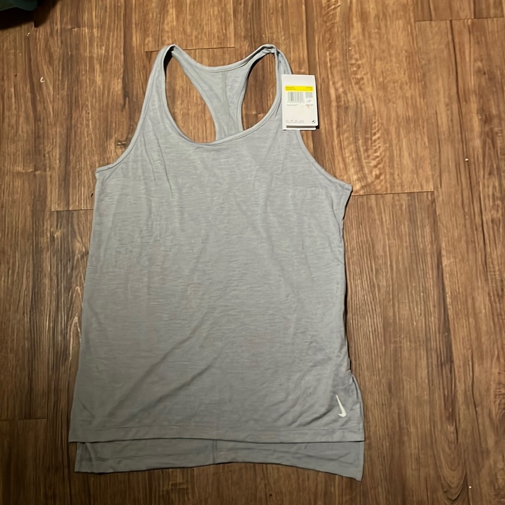 NWT Women’s is a beautiful “Nike Yoga Dri-Fit” top size small & in a nice grey